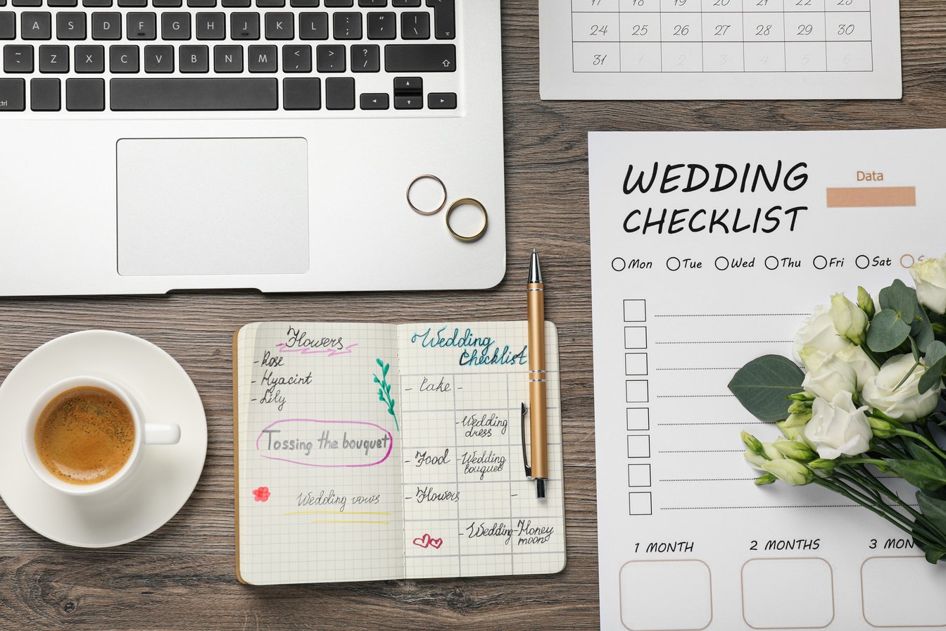 Flat Lay Composition with Wedding Planner and Checklist on Wooden Table